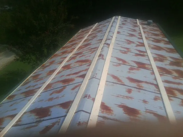 Rusted metal roof panels with new wood purlins before replacement — Storm Damage Roof Repair in Waterboro by Roofing Brothers